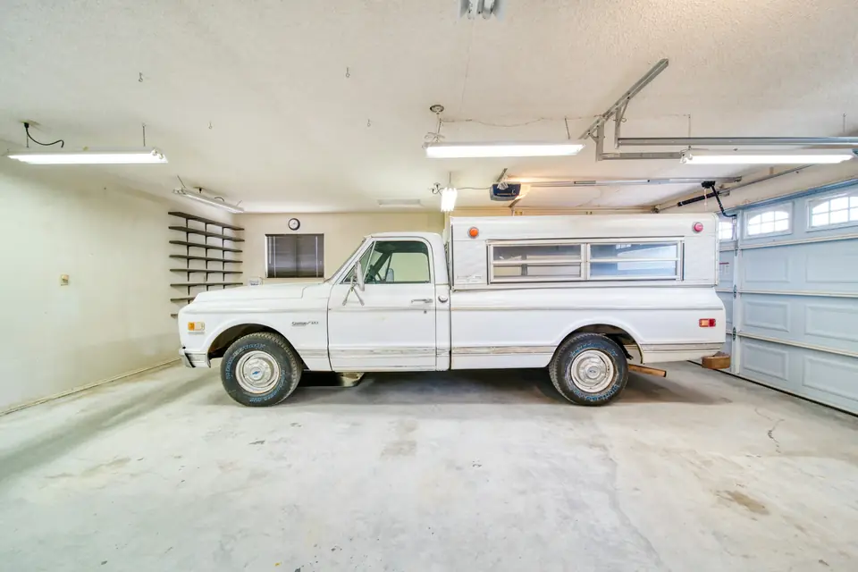 Pickup truck parked in a residential garage on a bare concrete slab