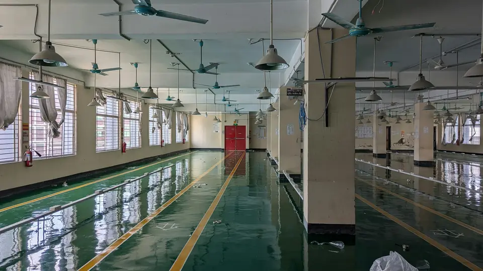 Factory hall with a green coated floor and yellow safety lane striping