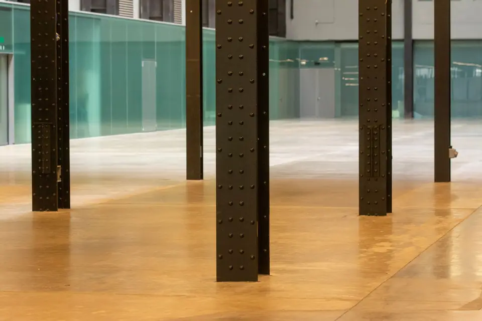 Polished concrete floor in an open commercial space with steel columns